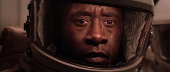 Movie still from “Mission to Mars” (2000), directed by Brian De Palma – A person wearing a helmet; Close Up shot, Overhead angle