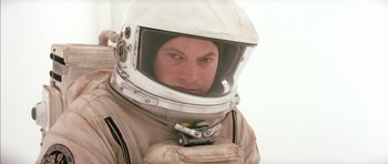 Movie still from “Mission to Mars” (2000), directed by Brian De Palma – A man in a spacesuit with a helmet on; Close Up shot, Low angle