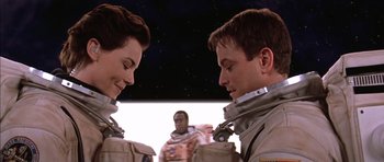 Movie still from “Mission to Mars” (2000), directed by Brian De Palma – Two people in space suits looking at each other; Close Up shot, Over the shoulder angle