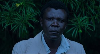 Movie still from “Mississippi Masala” (1991), directed by Mira Nair – A person wearing a white shirt; Close Up shot, High angle