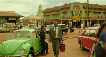 Movie still from “Mississippi Masala” (1991), directed by Mira Nair – A man walking down the street holding a briefcase; Wide shot, Low angle