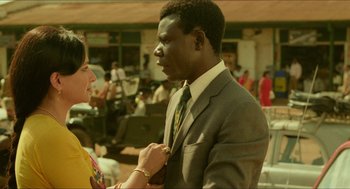 Movie still from “Mississippi Masala” (1991), directed by Mira Nair – A man in a suit and a woman in a yellow dress; Medium shot, Over the shoulder angle