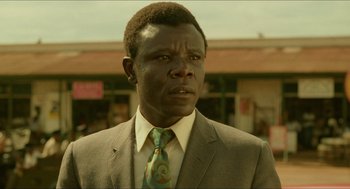 Movie still from “Mississippi Masala” (1991), directed by Mira Nair – A person wearing a suit and a tie; Close Up shot, Low angle