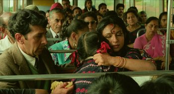 Movie still from “Mississippi Masala” (1991), directed by Mira Nair – A group of people sitting on a train; Medium shot, High angle