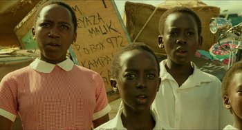 Movie still from “Mississippi Masala” (1991), directed by Mira Nair – Three young men standing next to each other in front of a sign; Close Up shot, Low angle