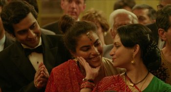 Movie still from “Mississippi Masala” (1991), directed by Mira Nair – Two women are smiling and talking to each other; Close Up shot, Over the shoulder angle