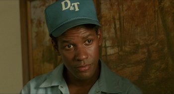 Movie still from “Mississippi Masala” (1991), directed by Mira Nair – A person wearing a hat; Close Up shot, Over the shoulder angle