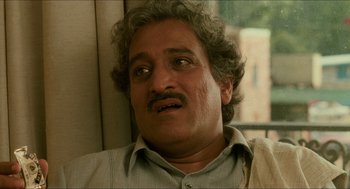 Movie still from “Mississippi Masala” (1991), directed by Mira Nair – A person with a mustache; Close Up shot, Low angle