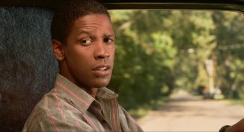 Movie still from “Mississippi Masala” (1991), directed by Mira Nair – A person sitting in a car; Close Up shot, Over the shoulder angle