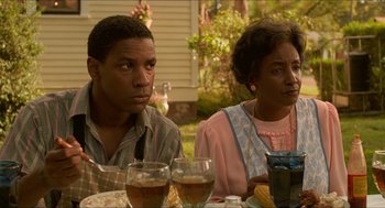Movie still from “Mississippi Masala” (1991), directed by Mira Nair – A man and a woman sitting at a dinner table; Close Up shot, Over the shoulder angle