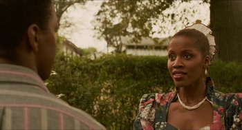 Movie still from “Mississippi Masala” (1991), directed by Mira Nair – A person wearing a floral shirt; Close Up shot, Over the shoulder angle