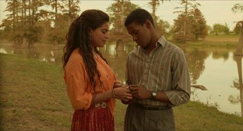 Movie still from “Mississippi Masala” (1991), directed by Mira Nair – A man and a woman standing next to each other; Medium shot, High angle