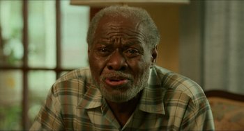 Movie still from “Mississippi Masala” (1991), directed by Mira Nair – An older man is looking at the camera; Close Up shot, Low angle