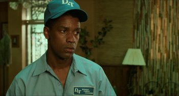 Movie still from “Mississippi Masala” (1991), directed by Mira Nair – A person wearing a cap; Close Up shot, Low angle