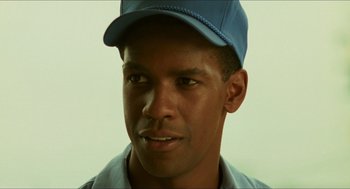 Movie still from “Mississippi Masala” (1991), directed by Mira Nair – A person wearing a hat; Close Up shot, Over the shoulder angle