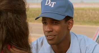 Movie still from “Mississippi Masala” (1991), directed by Mira Nair – A person wearing a hat; Close Up shot, Over the shoulder angle
