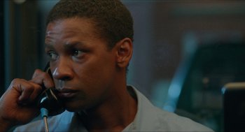 Movie still from “Mississippi Masala” (1991), directed by Mira Nair – A person with a cell phone; Close Up shot, Low angle