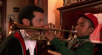 Movie still from “Mo' Better Blues” (1990), directed by Spike Lee – A man and a woman playing a trumpet; Close Up shot, High angle