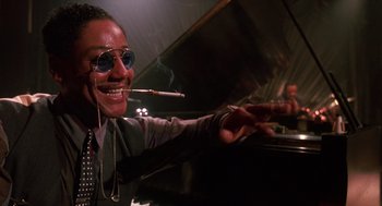 Movie still from “Mo' Better Blues” (1990), directed by Spike Lee – A man smoking a cigarette while sitting at a piano; Close Up shot, Low angle