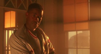 Movie still from “Mo' Better Blues” (1990), directed by Spike Lee – A man standing in front of a window in a room; Close Up shot, Low angle