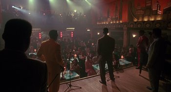 Movie still from “Mo' Better Blues” (1990), directed by Spike Lee – Two men standing in front of microphones in front of an audience; Extreme Wide shot, High angle