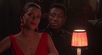 Movie still from “Mo' Better Blues” (1990), directed by Spike Lee – A man and a woman are sitting at a table; Close Up shot, Over the shoulder angle