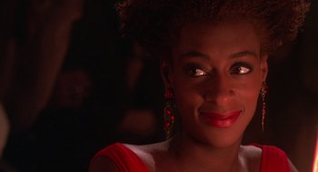 Movie still from “Mo' Better Blues” (1990), directed by Spike Lee – A person wearing a red dress; Close Up shot, Over the shoulder angle