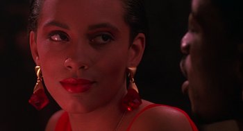 Movie still from “Mo' Better Blues” (1990), directed by Spike Lee – A person wearing a red dress; Close Up shot, Over the shoulder angle