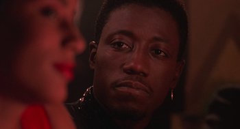 Movie still from “Mo' Better Blues” (1990), directed by Spike Lee – A person wearing a leather jacket; Close Up shot, Over the shoulder angle