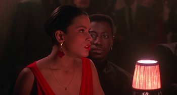 Movie still from “Mo' Better Blues” (1990), directed by Spike Lee – A woman in a red dress and a man in a black shirt; Close Up shot, Over the shoulder angle