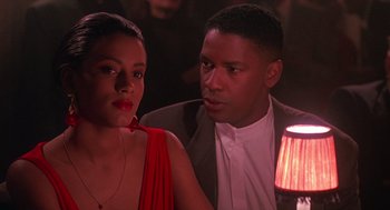 Movie still from “Mo' Better Blues” (1990), directed by Spike Lee – A man and a woman sitting next to each other in a room; Close Up shot, Over the shoulder angle