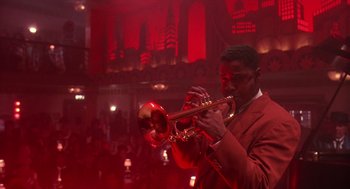 Movie still from “Mo' Better Blues” (1990), directed by Spike Lee – A man in a red suit playing a trumpet; Medium shot, Low angle