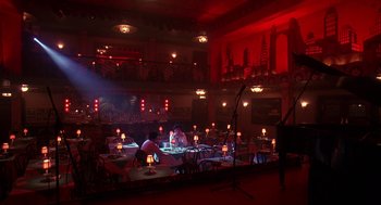 Movie still from “Mo' Better Blues” (1990), directed by Spike Lee – Two people are sitting at a table in a theater; Wide shot, High angle