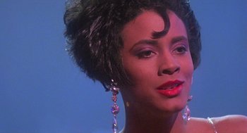 Movie still from “Mo' Better Blues” (1990), directed by Spike Lee – A person wearing a dress; Close Up shot, Over the shoulder angle