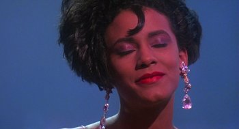 Movie still from “Mo' Better Blues” (1990), directed by Spike Lee – A person wearing a dress; Close Up shot, Low angle