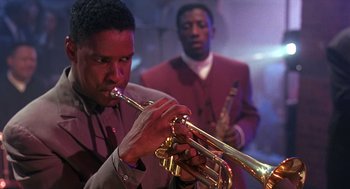 Movie still from “Mo' Better Blues” (1990), directed by Spike Lee – A man plays a trumpet while another man plays a saxophone; Close Up shot, Low angle
