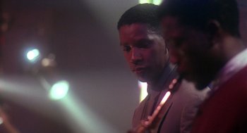 Movie still from “Mo' Better Blues” (1990), directed by Spike Lee – A man is holding a stick in his hand; Close Up shot, Low angle