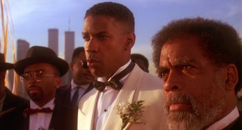 Movie still from “Mo' Better Blues” (1990), directed by Spike Lee – A group of men standing next to each other in front of a building; Close Up shot, Low angle