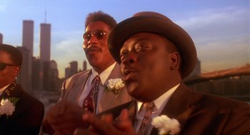Movie still from “Mo' Better Blues” (1990), directed by Spike Lee – A couple of men standing next to each other in suits; Close Up shot, Low angle