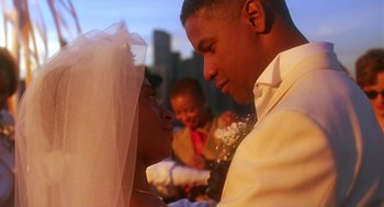 Movie still from “Mo' Better Blues” (1990), directed by Spike Lee – A man and a woman holding hands in front of a baby; Close Up shot, Low angle