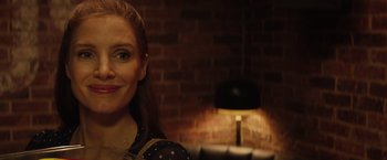 Movie still from “Molly's Game” (2017), directed by Aaron Sorkin – A person sitting in front of a fire place; Close Up shot, Over the shoulder angle