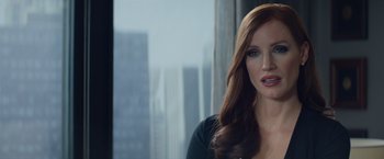 Movie still from “Molly's Game” (2017), directed by Aaron Sorkin – A woman with long red hair is looking at the camera; Close Up shot, Over the shoulder angle