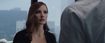 Movie still from “Molly's Game” (2017), directed by Aaron Sorkin – A woman with long red hair looking into a mirror; Close Up shot, Over the shoulder angle
