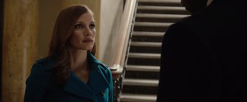 Movie still from “Molly's Game” (2017), directed by Aaron Sorkin – A woman standing next to a set of stairs; Close Up shot, Over the shoulder angle