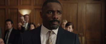 Movie still from “Molly's Game” (2017), directed by Aaron Sorkin – A person wearing a suit and tie; Close Up shot, Over the shoulder angle