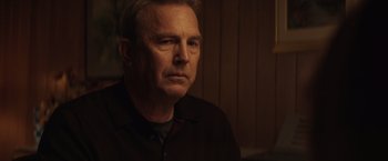 Movie still from “Molly's Game” (2017), directed by Aaron Sorkin – An older man in a black shirt is looking into the distance; Close Up shot, Over the shoulder angle