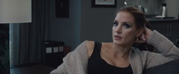Movie still from “Molly's Game” (2017), directed by Aaron Sorkin – A woman sitting on a couch with her eyes closed; Close Up shot, Over the shoulder angle