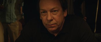 Movie still from “Molly's Game” (2017), directed by Aaron Sorkin – A person wearing a black shirt; Close Up shot, Low angle