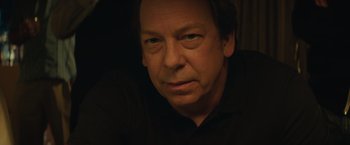 Movie still from “Molly's Game” (2017), directed by Aaron Sorkin – A person wearing a black shirt; Close Up shot, Low angle