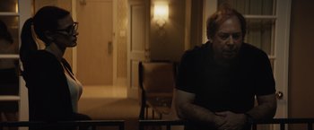 Movie still from “Molly's Game” (2017), directed by Aaron Sorkin – A man sitting at a table in front of a mirror; Medium shot, Over the shoulder angle